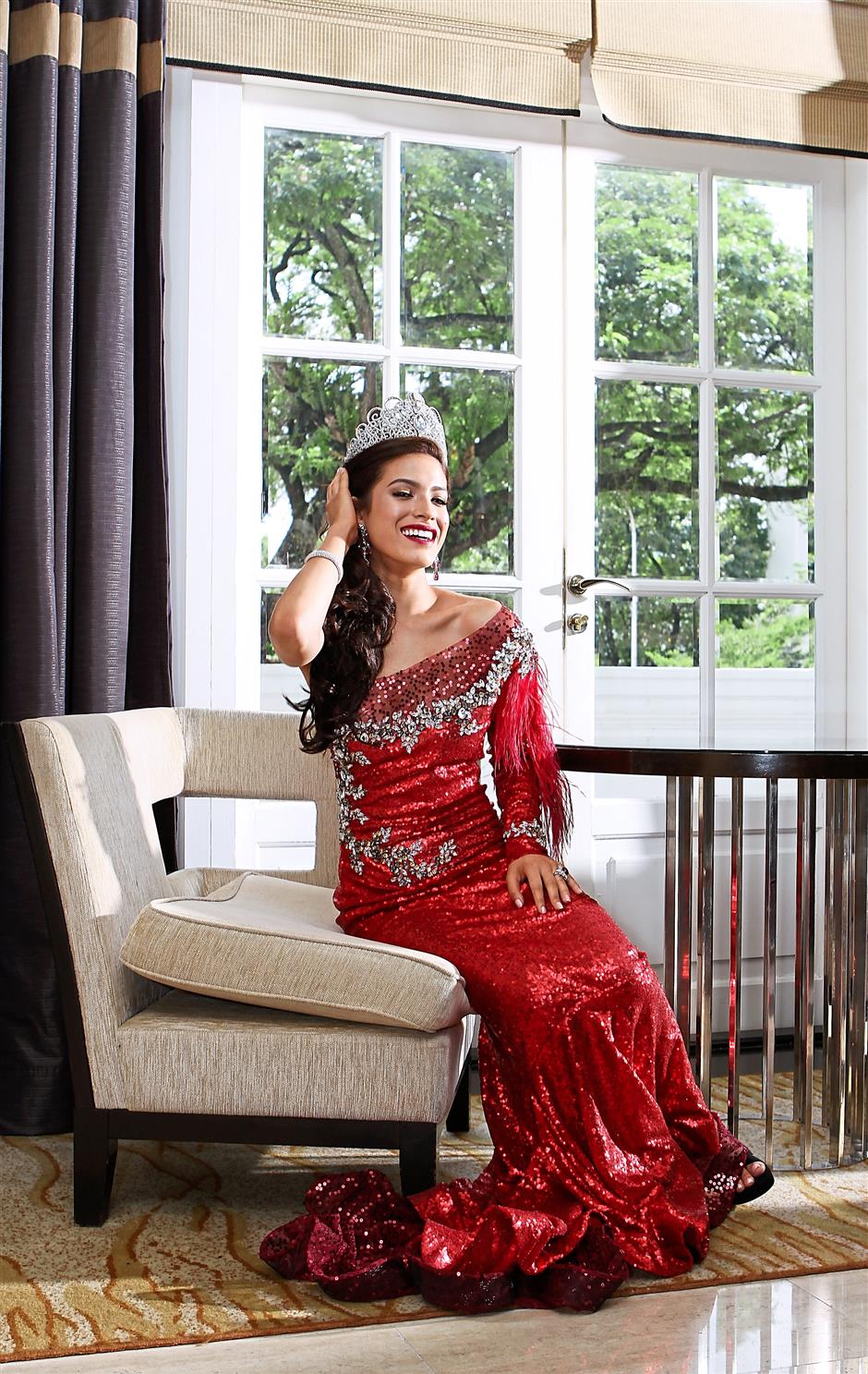 James in a Hasfitri Yusof dress and her winning crown. Photo: The Star/Yap Chee Hong