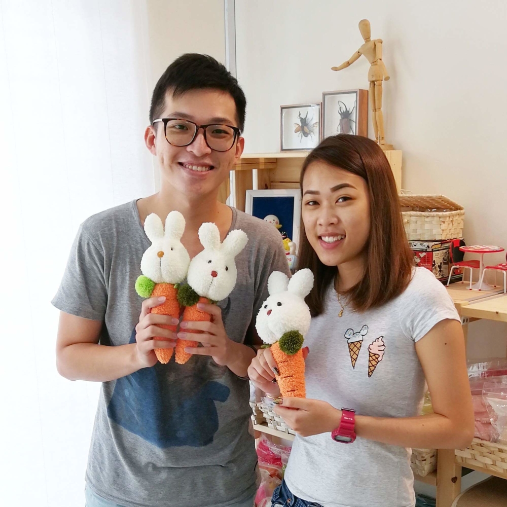 Lean Chin Keong and his student Kaylee Tan with their sock toys.